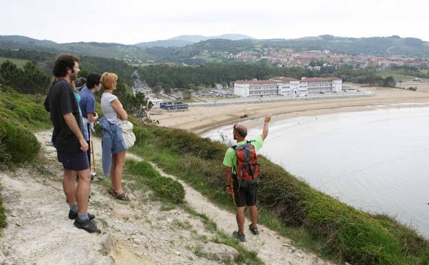 Un grupo de personas pasean por la costa de Gorliz./pedro urresti