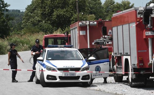 Greek agents block a road near the place where the plane crashed. 