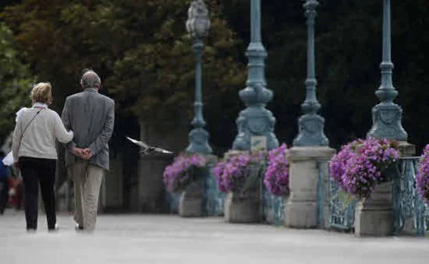 A retired couple taking a walk. 